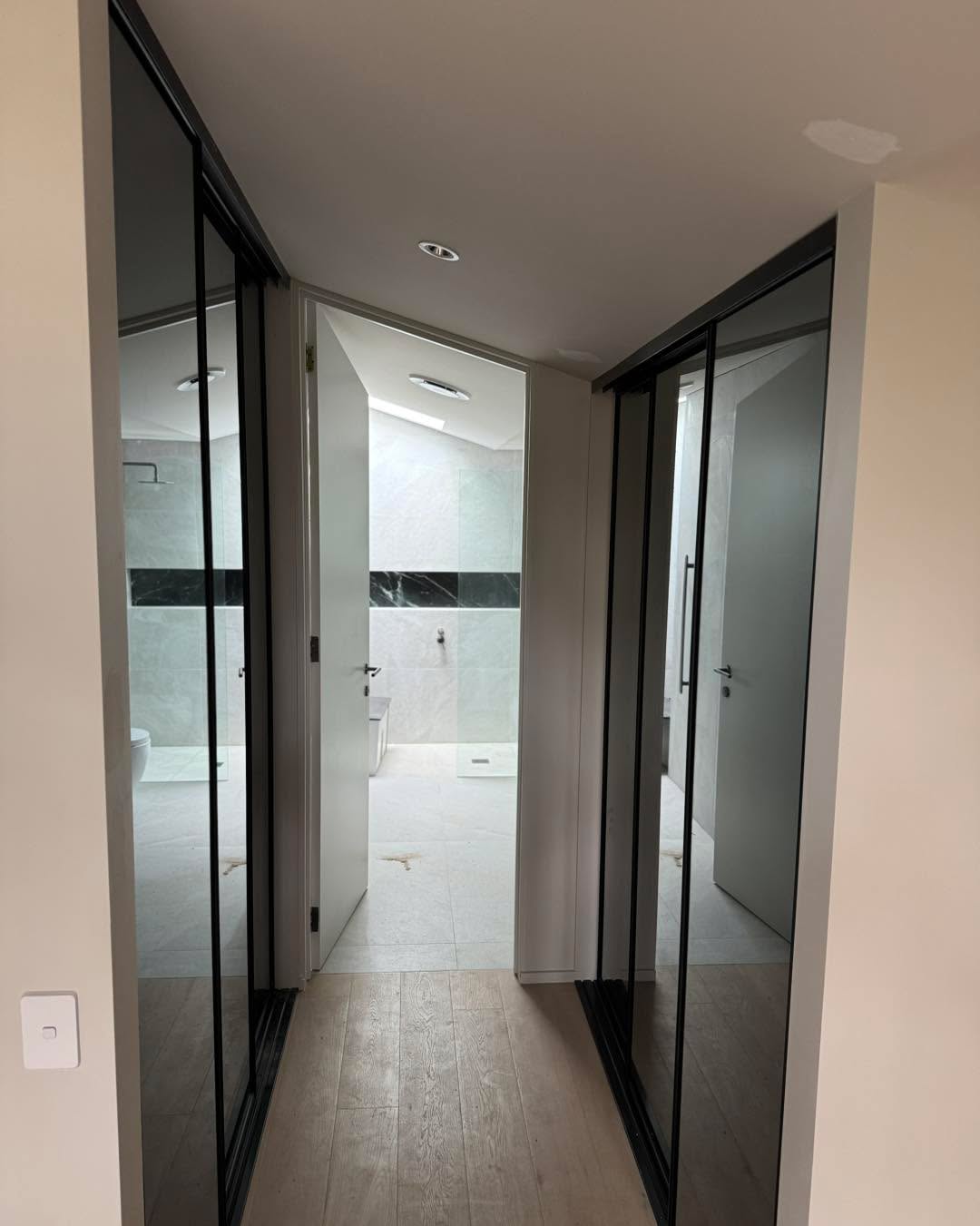 Hallway with black-framed sliding doors