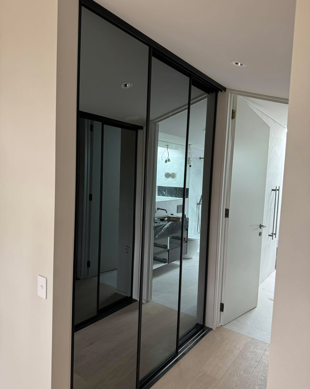 Modern bedroom with black-framed sliding doors